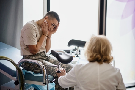 Doctor consoles a soldier woman who has had some bad news
